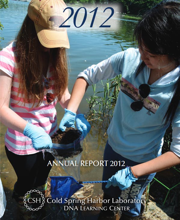 Annual report cover with a photograph of two female students wearing blue gloves collecting soil samples by the harbor's edge on a bright sunny day