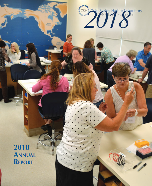 Annual report cover with a color photo of a DNALC educator with more than a dozen science educators in a DNALC lab classroom