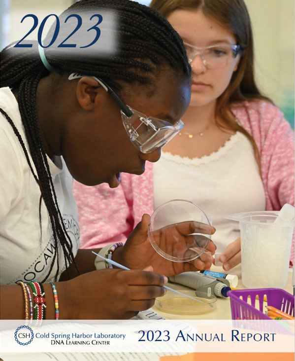 Annual report cover showing Two young girls working together at a laboratory desk