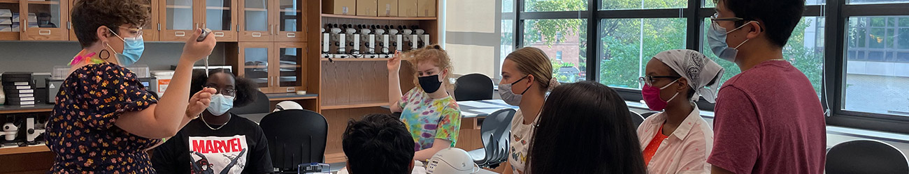 An educator and several students in a DNALC NYC laboratory classroom