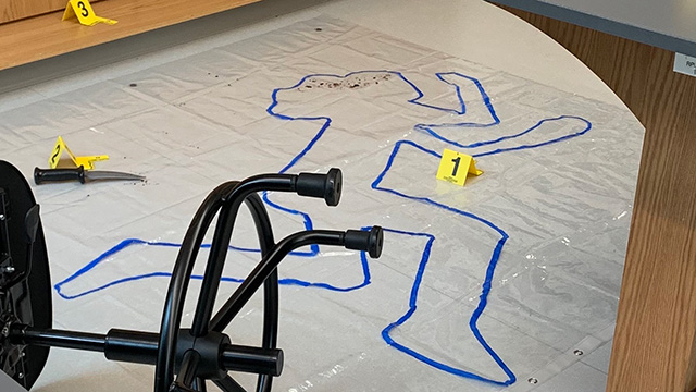 Crime scene body outline with chair and knif on the floor