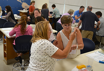 Several educators participate in a workshop in a DNALC laboratory classroom